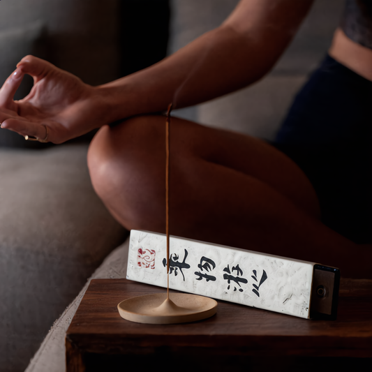 Meditation with incense — a single Shyang Studio stick burning beside a quiet seated cushion